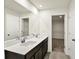 Modern bathroom with double vanity, white countertops, and a large mirror at 7132 Sterling Way, Brownsburg, IN 46112