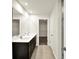 Modern bathroom features a double vanity, tile flooring, and walk-in closet for ample storage at 7132 Sterling Way, Brownsburg, IN 46112