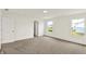 Bright bedroom featuring soft carpet, two windows, and neutral walls at 7132 Sterling Way, Brownsburg, IN 46112