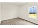 This bedroom features carpet and a window overlooking a grassy yard at 7132 Sterling Way, Brownsburg, IN 46112