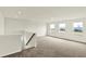 Spacious bonus room featuring soft carpet, natural light, and stairs at 7132 Sterling Way, Brownsburg, IN 46112