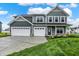 Beautiful two-story home featuring a three-car garage, stone accents, and well-manicured lawn at 7132 Sterling Way, Brownsburg, IN 46112