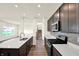 Beautiful kitchen features stainless steel appliances, dark wood cabinets, white countertops and a large island at 7132 Sterling Way, Brownsburg, IN 46112
