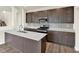 Close-up of the kitchen with stainless steel appliances and a white quartz countertop island at 7132 Sterling Way, Brownsburg, IN 46112