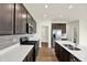 This kitchen boasts stainless steel appliances, dark wood cabinets, white countertops and a large island at 7132 Sterling Way, Brownsburg, IN 46112
