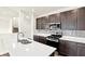 Modern kitchen with a stainless steel range and quartz countertops at 7132 Sterling Way, Brownsburg, IN 46112