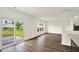 Bright living room with sliding glass door, wood floors, and open to the kitchen at 7132 Sterling Way, Brownsburg, IN 46112