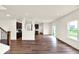 Spacious living room boasts wood floors, recessed lighting, and an open layout flowing into the kitchen at 7132 Sterling Way, Brownsburg, IN 46112
