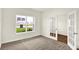 Bright office with a large window, plush carpet, and French doors leading to the hallway at 7132 Sterling Way, Brownsburg, IN 46112