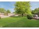 Large, well-maintained backyard with lush green grass, wooden fence, and mature trees at 7606 Old Oakland Blvd E Dr, Indianapolis, IN 46236