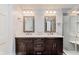 Bathroom boasts double vanity, granite countertop, mosaic mirror trim, and a glass shower at 7606 Old Oakland Blvd E Dr, Indianapolis, IN 46236