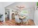 Bright dining area featuring a rustic wood table set, chandelier, and easy access to kitchen at 7606 Old Oakland Blvd E Dr, Indianapolis, IN 46236