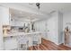 Bright kitchen features white cabinetry, stainless steel appliances, and breakfast bar with seating at 7606 Old Oakland Blvd E Dr, Indianapolis, IN 46236