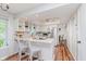 Bright kitchen boasts white cabinetry, stainless steel appliances, and a convenient breakfast bar seating area at 7606 Old Oakland Blvd E Dr, Indianapolis, IN 46236