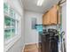Laundry room includes washer, dryer, cabinet storage, and a window offering natural light at 7606 Old Oakland Blvd E Dr, Indianapolis, IN 46236