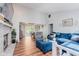Spacious living room featuring vaulted ceilings, brick fireplace, and open access to dining area at 7606 Old Oakland Blvd E Dr, Indianapolis, IN 46236