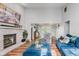 Open-concept living room with high ceilings, a brick fireplace, and large windows with natural light at 7606 Old Oakland Blvd E Dr, Indianapolis, IN 46236