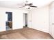 Spacious main bedroom with plush carpet, ceiling fan, and an en suite bathroom at 7611 Misty Meadow Dr, Indianapolis, IN 46217