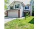 Charming two-story home boasts a large front yard, two-car garage and updated siding and windows at 7611 Misty Meadow Dr, Indianapolis, IN 46217