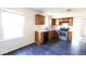 Galley kitchen features stainless steel appliances, wood cabinets, and a window above the sink at 7611 Misty Meadow Dr, Indianapolis, IN 46217