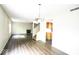 Bright living room includes wood-look flooring, fireplace, and updated light fixtures at 7611 Misty Meadow Dr, Indianapolis, IN 46217