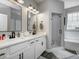 Elegant bathroom features double sinks, white cabinetry, and a separate shower with a mosaic floor at 8112 Joni Ave, Martinsville, IN 46151