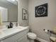 Half bath with toilet, vanity and modern lighting and wood look floors at 8112 Joni Ave, Martinsville, IN 46151