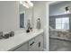 Bathroom vanity featuring granite counters, white cabinets, updated lighting and access to bedroom at 8112 Joni Ave, Martinsville, IN 46151