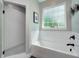 Bright bathroom featuring a modern tub, sleek fixtures, and a shower with a tiled surround and mosaic floor at 8112 Joni Ave, Martinsville, IN 46151