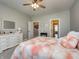 Comfortable bedroom featuring plush gray carpet, a ceiling fan, and access to other areas of the home at 8112 Joni Ave, Martinsville, IN 46151