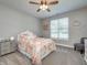 Bedroom with updated ceiling fan, plush gray carpet, painted gray walls, and bright windows at 8112 Joni Ave, Martinsville, IN 46151