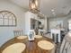 Bright breakfast nook adjacent to the kitchen with a wooden table, four chairs, and modern lighting at 8112 Joni Ave, Martinsville, IN 46151