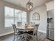 Sunlit breakfast nook with a round wooden table, four chairs, and statement lighting at 8112 Joni Ave, Martinsville, IN 46151