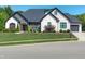 Beautiful home with stone and brick exterior, manicured lawn, black roof, and an attached two-car garage at 8112 Joni Ave, Martinsville, IN 46151
