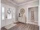 Inviting foyer with decorative rug, stylish cabinet, and a charming ladder display, all illuminated by natural light at 8112 Joni Ave, Martinsville, IN 46151