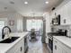 Clean kitchen with white cabinets, stainless steel appliances, and view of the breakfast nook at 8112 Joni Ave, Martinsville, IN 46151
