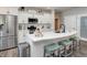 Bright white kitchen with stainless steel appliances, kitchen island with seating, and pantry access at 8112 Joni Ave, Martinsville, IN 46151