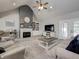 Inviting living room with vaulted ceilings, a stone fireplace, built-in shelving, and comfortable seating at 8112 Joni Ave, Martinsville, IN 46151