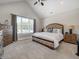 Serene main bedroom with a large window overlooking a pool, neutral color palette, and ensuite bathroom at 8112 Joni Ave, Martinsville, IN 46151