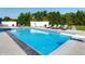 Inviting swimming pool surrounded by chaise lounges, manicured landscaping, and a diving board at 8112 Joni Ave, Martinsville, IN 46151