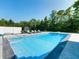 Stunning pool area with chaise lounges, lush landscaping, and a diving board for summer fun at 8112 Joni Ave, Martinsville, IN 46151