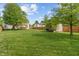 Expansive backyard featuring lush lawn, mature trees, shed, and wooden privacy fence at 828 Breaside Ln, Greenwood, IN 46143