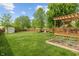 Beautiful backyard with a wooden deck, pergola, shed, garden, and mature trees at 828 Breaside Ln, Greenwood, IN 46143