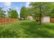 Spacious backyard featuring a well-maintained lawn, fence, and storage shed at 828 Breaside Ln, Greenwood, IN 46143