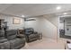 Finished basement with reclining furniture, neutral carpet, and access to a stairway at 828 Breaside Ln, Greenwood, IN 46143