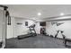 Finished basement featuring workout equipment and rubber flooring at 828 Breaside Ln, Greenwood, IN 46143