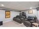 Cozy basement lounge area with reclining chairs, dark colored trim, and carpeted floor at 828 Breaside Ln, Greenwood, IN 46143