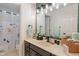 Well-lit bathroom featuring dark wood cabinetry, a decorative shower curtain, and earth tone decor at 828 Breaside Ln, Greenwood, IN 46143