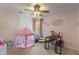 Playful pink themed bedroom with a play tent, desk, ceiling fan, and carpeted floor at 828 Breaside Ln, Greenwood, IN 46143