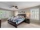 Comfortable bedroom featuring neutral colors, ceiling fan, and shuttered windows for optimal light control at 828 Breaside Ln, Greenwood, IN 46143